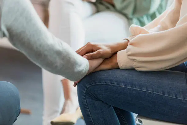 A comforting moment between two people, one offering steady support to the other