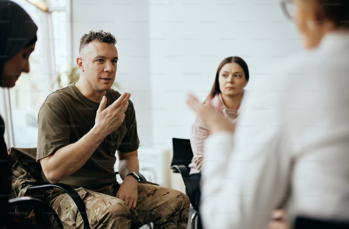 A small group sitting together in conversation, listening and supporting one another